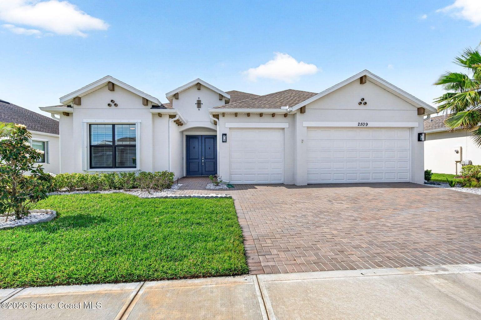 Double door entry/ Black Frame windows/ 3 car garage/ waterfront
