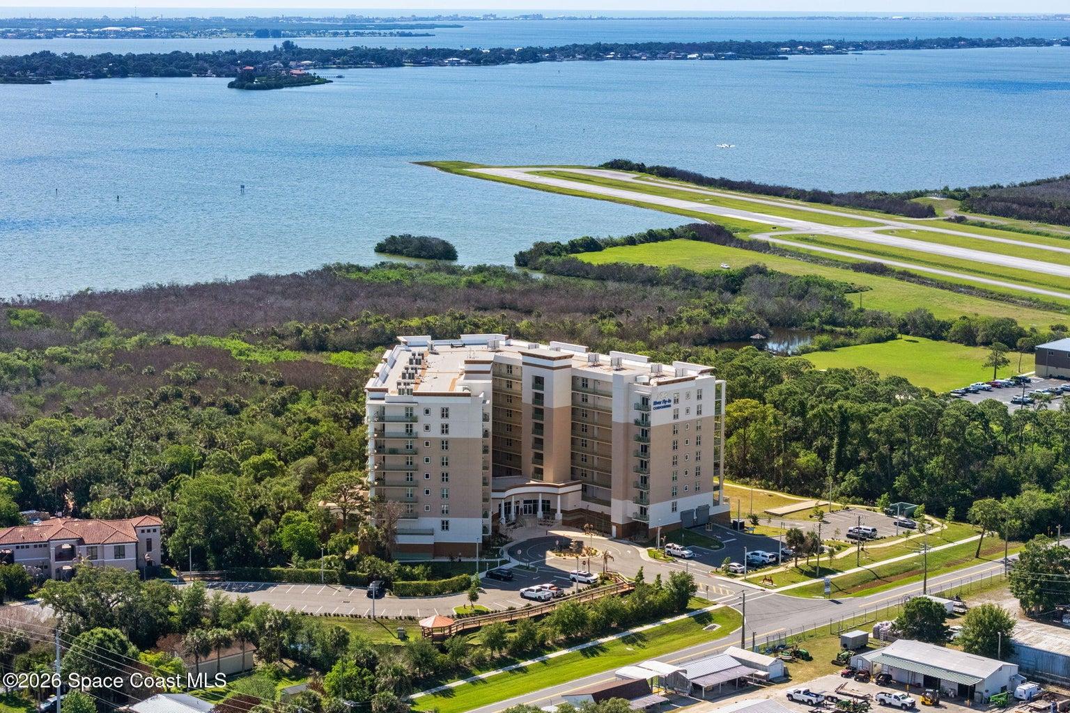 River Fly-In Condominiums at 735 Pilot Lane in Merritt Island, Florida, a luxury waterfront fly-in condo community designed for pilots and aviation enthusiasts, offering marina-style living, private airport access, resort amenities, and a premier Space Coast location near Cocoa Beach, Port Canaveral, Kennedy Space Center, SpaceX, and Blue Origin.