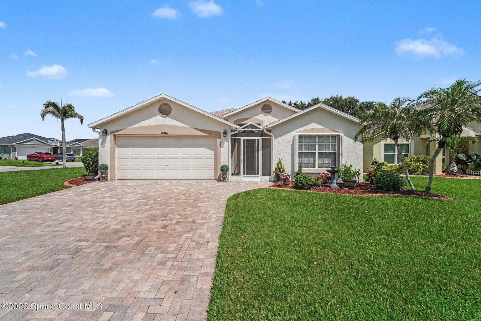 Corner-lot home with widened paver driveway.
