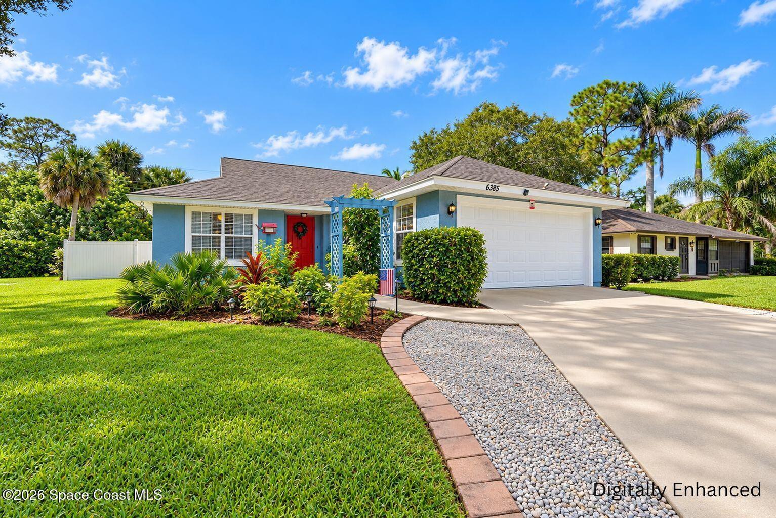 Light blue exterior with a contrasting red entry door and a white garage door