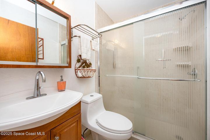Hall bathroom has walk-in shower