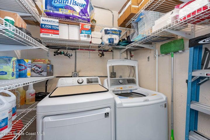 Washer and dryer room with plenty of extra storage located on the screened porch