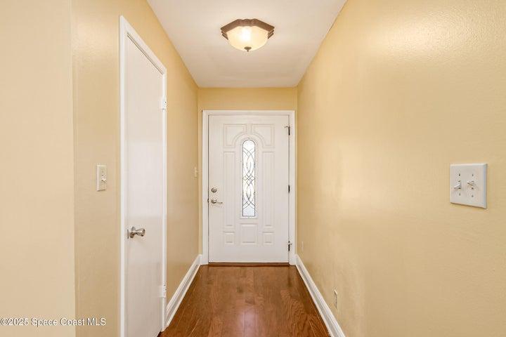 View to front entryway and hall closet that is plumbed for another half bath.