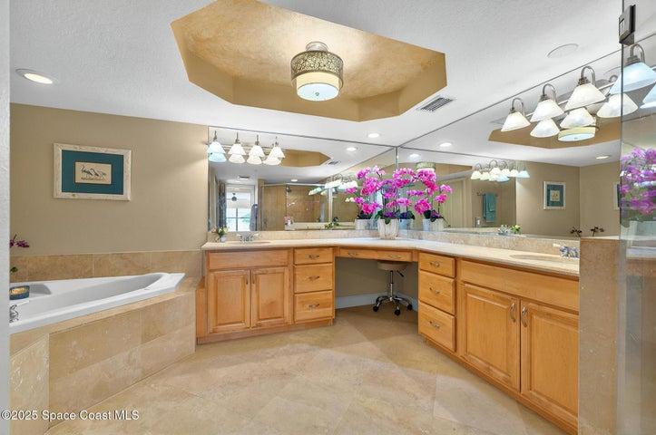 Primary bathroom with spa tub and separate walk in shower.