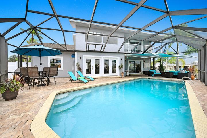Large heated and screened pool and patio with room for seating and firepit and grilling.