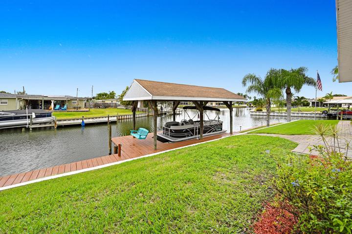 Covered Boat dock and lift on sunny west yard.