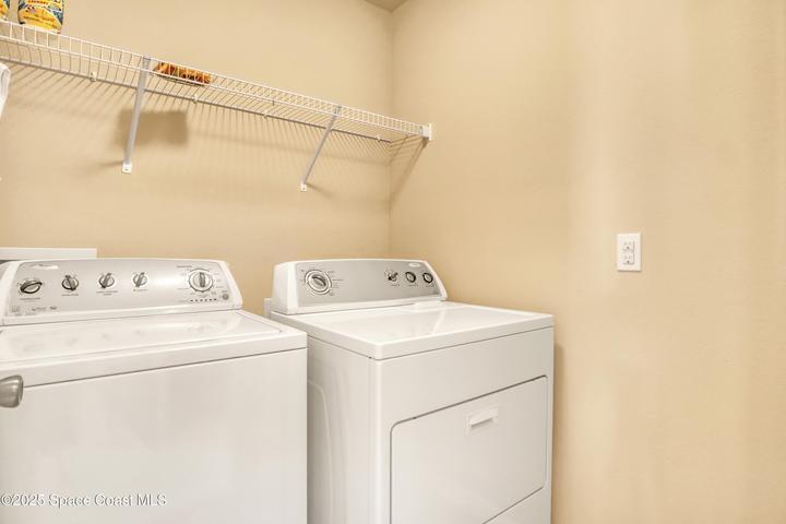 A dedicated laundry space equipped with a full-size washer and dryer, providing added convenience for daily living.