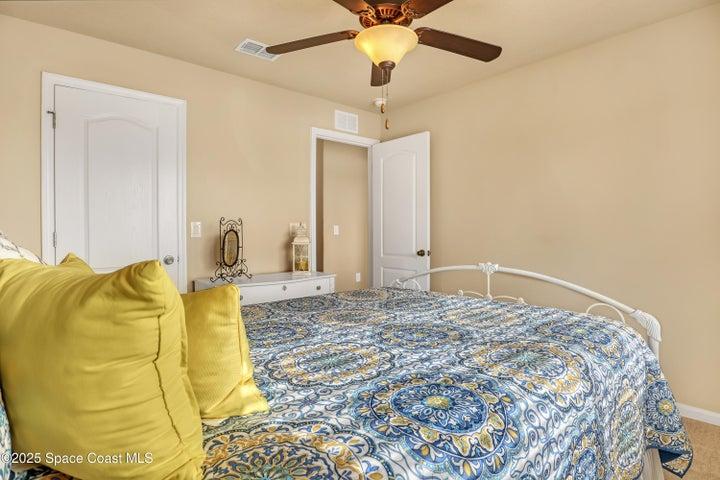 Your visitors will feel right at home in this tranquil bedroom featuring soft neutral tones and abundant natural light.