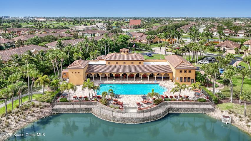 Perfectly positioned between the Atlantic Ocean and the Banana River, this aerial perspective highlights the serene, secure enclave of your new neighborhood in the heart of Satellite Beach.