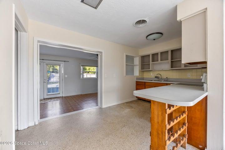 Kitchen off the living room which opens to the den.