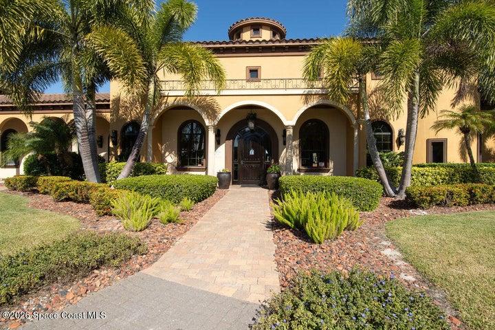 Luxurious community clubhouse with tropical landscaping.