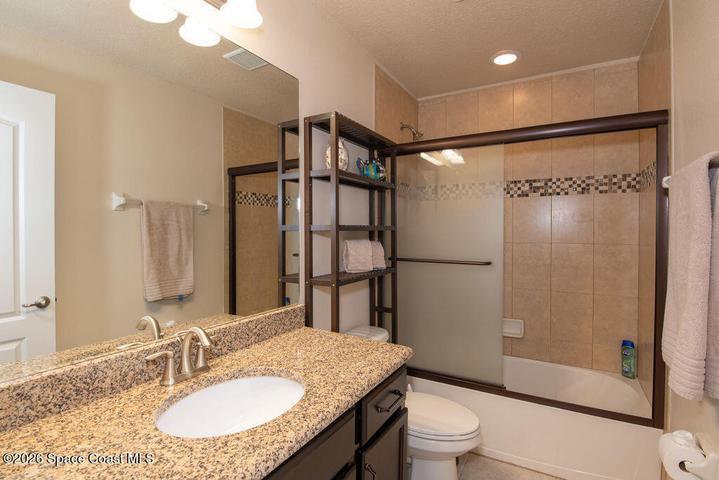 Modern bath with granite vanity.