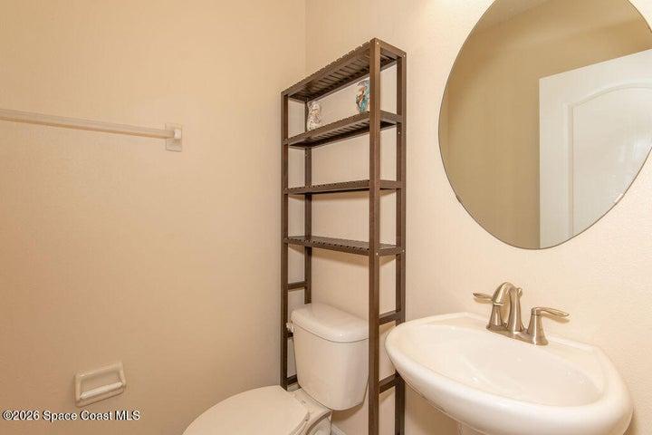 Downstairs powder room with pedestal sink.