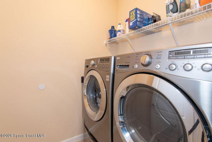 Convenient indoor laundry with overhead storage.