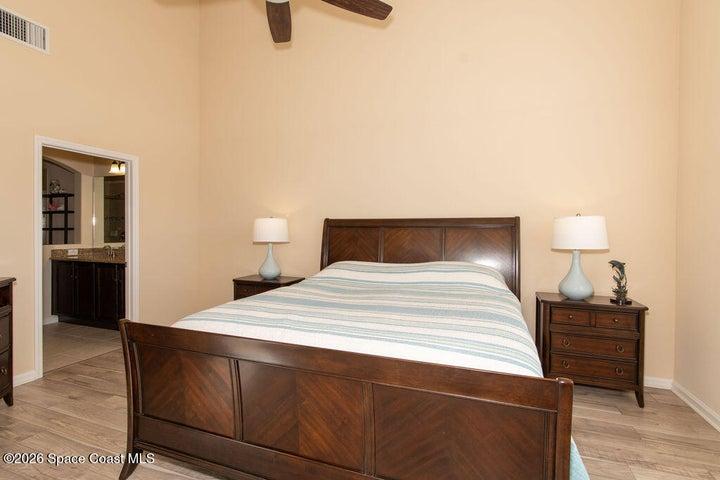 Primary bedroom with vaulted ceilings.
