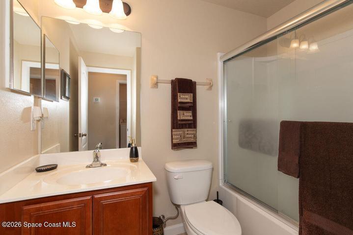 Features a clean vanity and contemporary fixtures, conveniently located to serve the guest bedrooms.