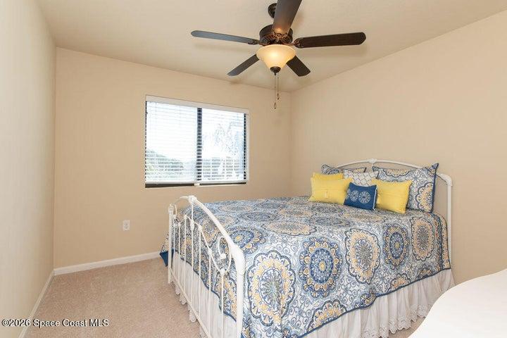 his bright and oversized bedroom features a large window and neutral decor, making it a perfect guest retreat, nursery, or sophisticated home office.