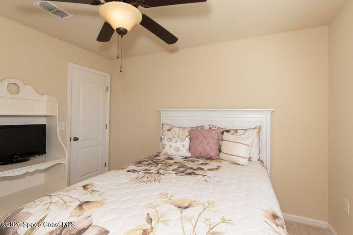 This well-appointed bedroom offers ample closet space and natural light, ensuring a welcoming stay for family and friends.