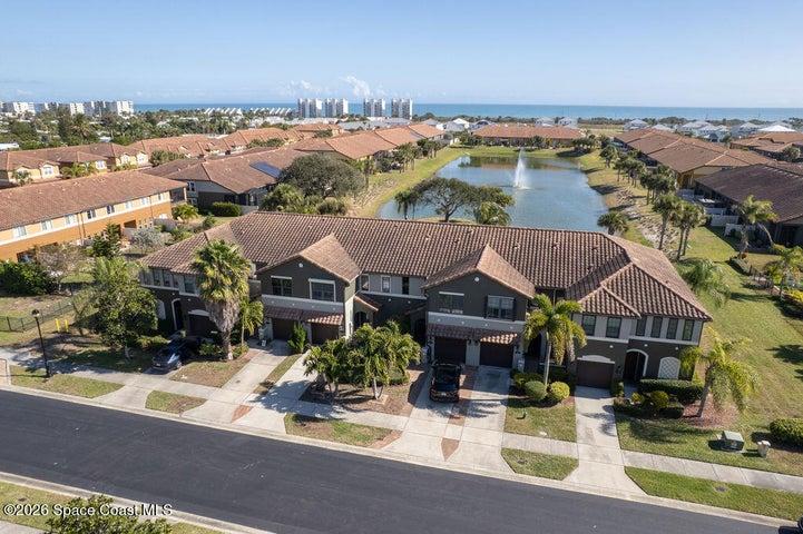 A wide-angle perspective of the tropical landscaping and modern architecture, illustrating the peaceful atmosphere of this Satellite Beach enclave.