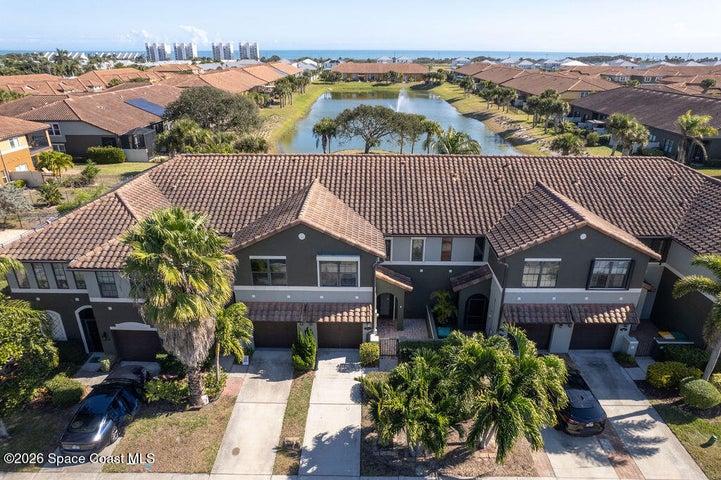 This aerial highlights the home's desirable position within the community, offering a blend of privacy and open water views.