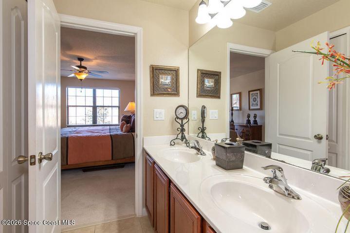 Plenty of room for two with expansive counter space, stylish cabinetry, and bright vanity lighting.