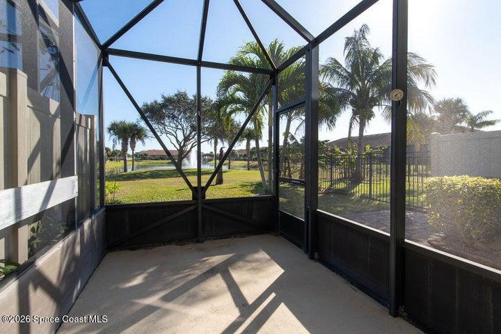 The expansive screen enclosure provides a seamless connection to the outdoors, offering a shaded sanctuary to unwind and watch the local wildlife.