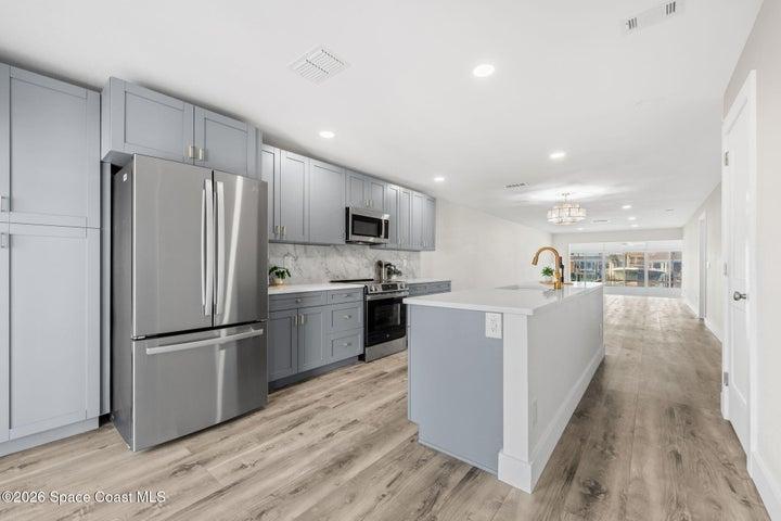 galley kitchen opened up, with added pantry left of fridge
