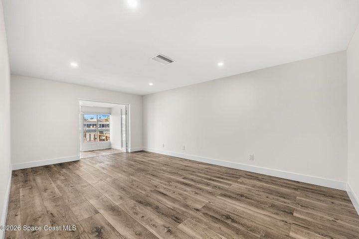 Primary bedroom with french doors to sunroom