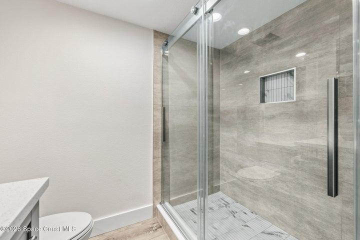 beautiful tiled shower with sliding shower door