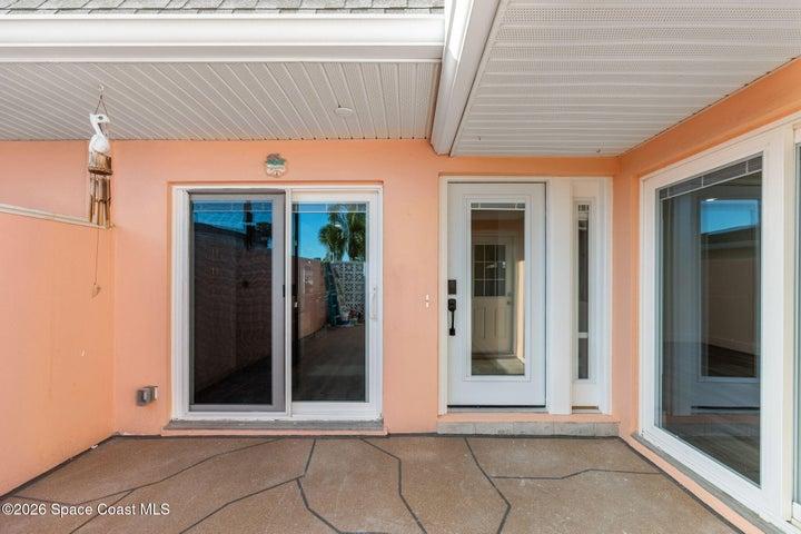 courtyard off kitchen and front entry door, with guest bedroom private slider