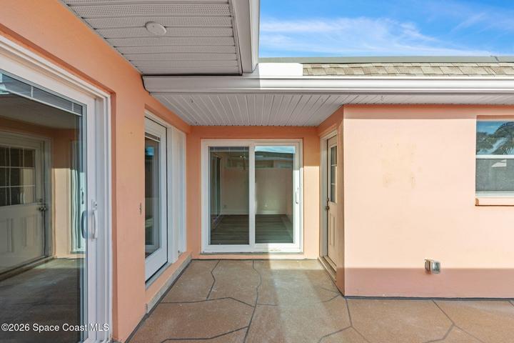 Garage entry door to the right of guest sliders