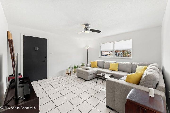 Living room space with lots of natural light and tile flooring