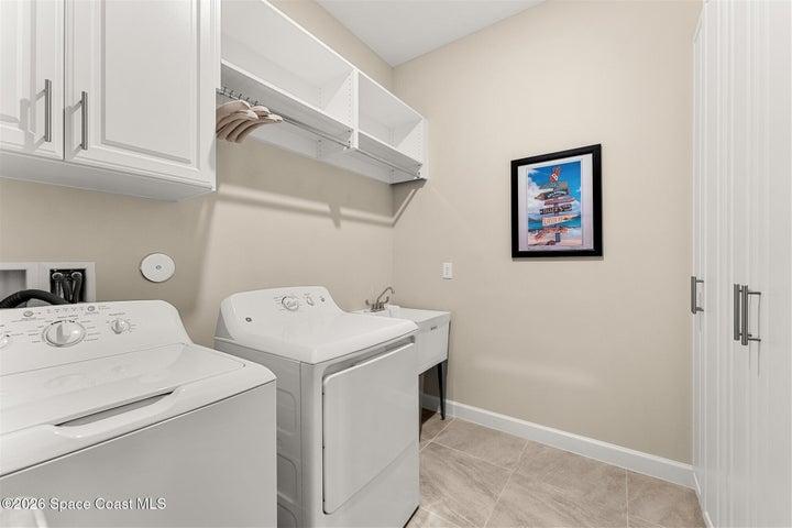 Laundry room with sink and additional storage