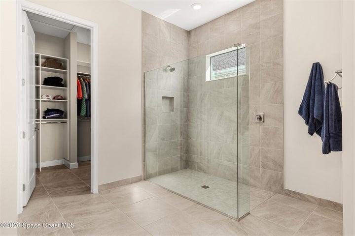 The primary bath offers a spacious shower, double sinks and custom closet.