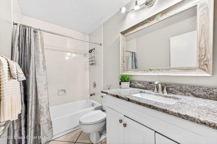 attached tub shower bathroom to second bedroom with granite countertops