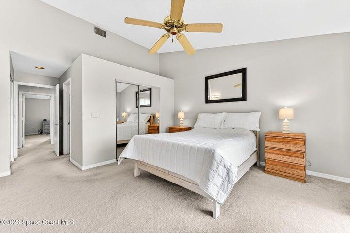 Large primary bedroom with lots of natural light