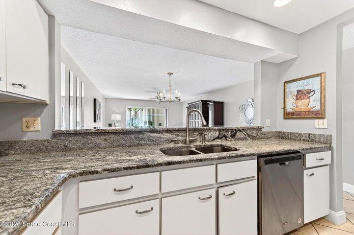 Kitchen with view into living area granite countertops