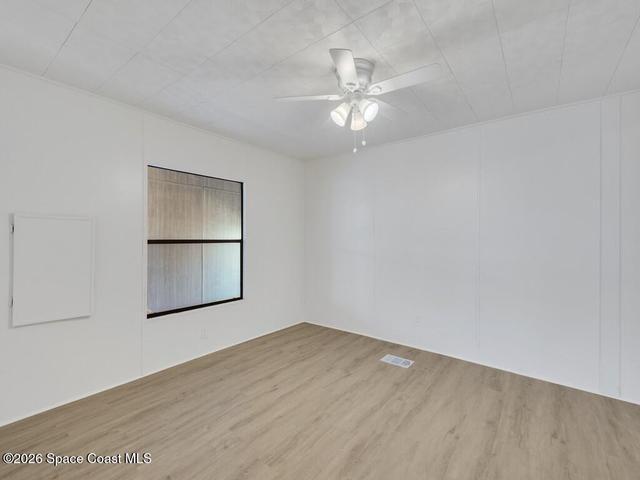 Spare room with light wood finished floors and ceiling fan
