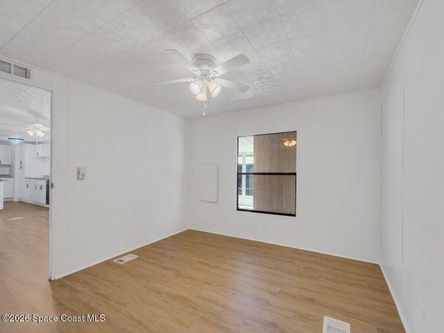 Unfurnished room featuring a ceiling fan and light wood finished floors