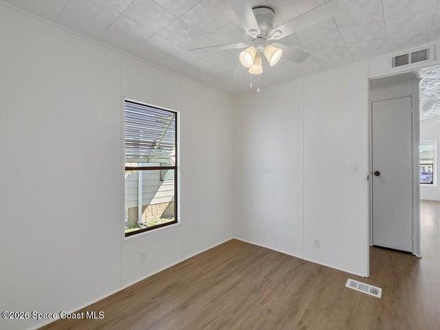 Spare room featuring a ceiling fan and wood finished floors