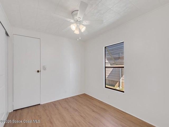 Unfurnished bedroom featuring light wood-style flooring, ceiling fan, and a closet