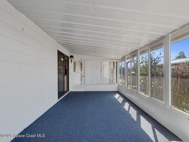 Unfurnished sunroom with vaulted ceiling