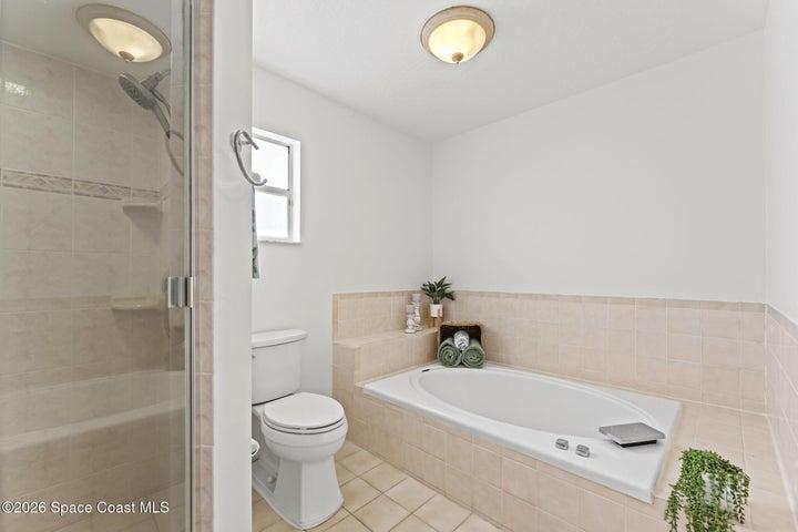 upstairs bathroom with walk in shower and soaking tub