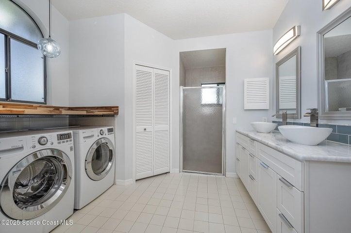 Primary bathroom, laundry, walk-in shower, two closets and double sink vanity, private water closet