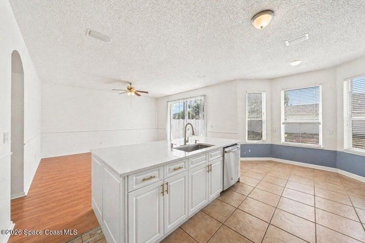 kitchen island with breakfast nook and formal dining/back room view