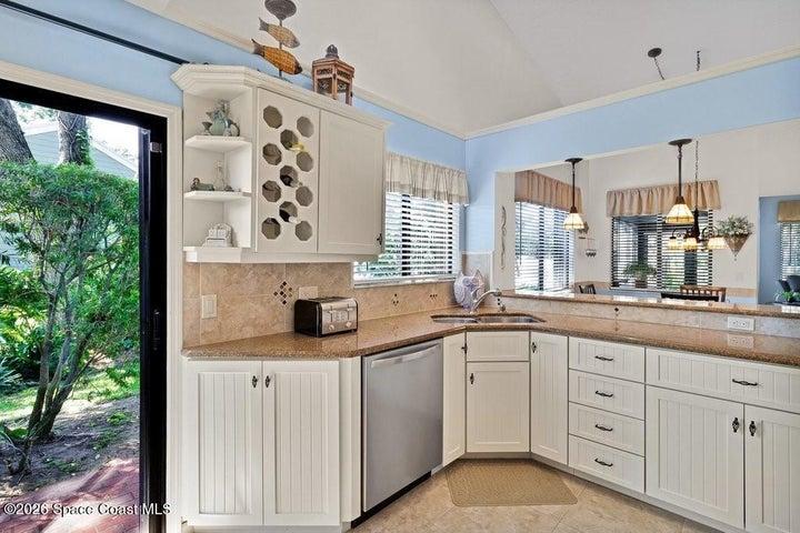 Great kitchen layout with custom tile backsplash & wonderful long countertop's to create your culinary favorites. Storage has been well designed including space for your "vino" collection!