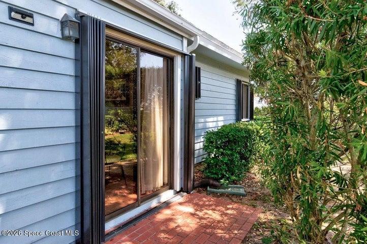 Side brick patio located off Kitchen/Breakfast nook is a great space to grill up your favorite BBQ.