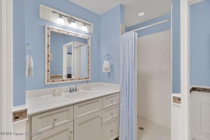 Primary bath includes walk in shower with solid smooth surface walls makes for easy care & maintenance.