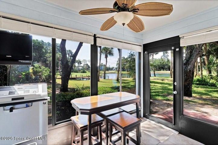 Sunroom off Dining/Living room with remarkable views of pond, fountain, foot bridge and golf course.