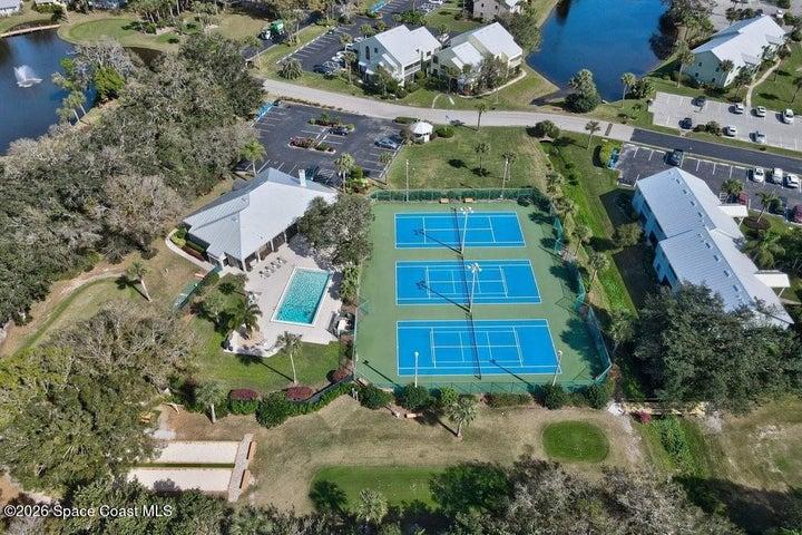 Aerial of community clubhouse, 3 lighted tennis/pickleball courts, heated pool and much more in this resort style community.